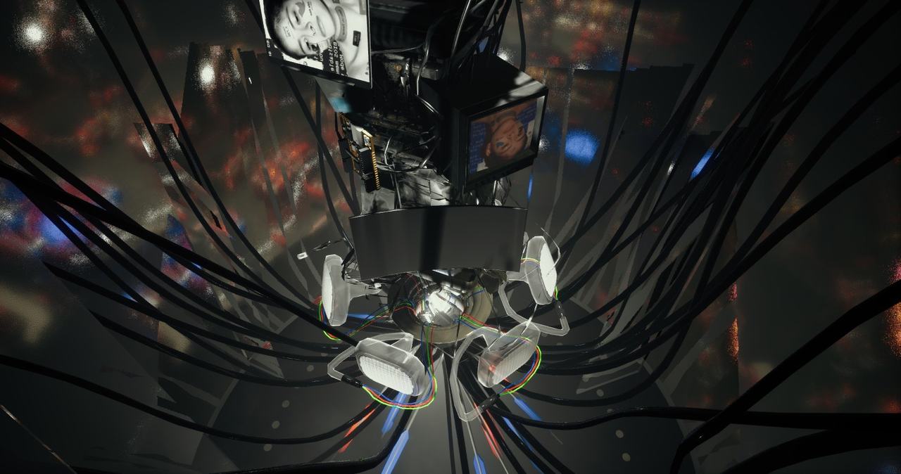 Black cables converging on a pale mechanical device seen from below.