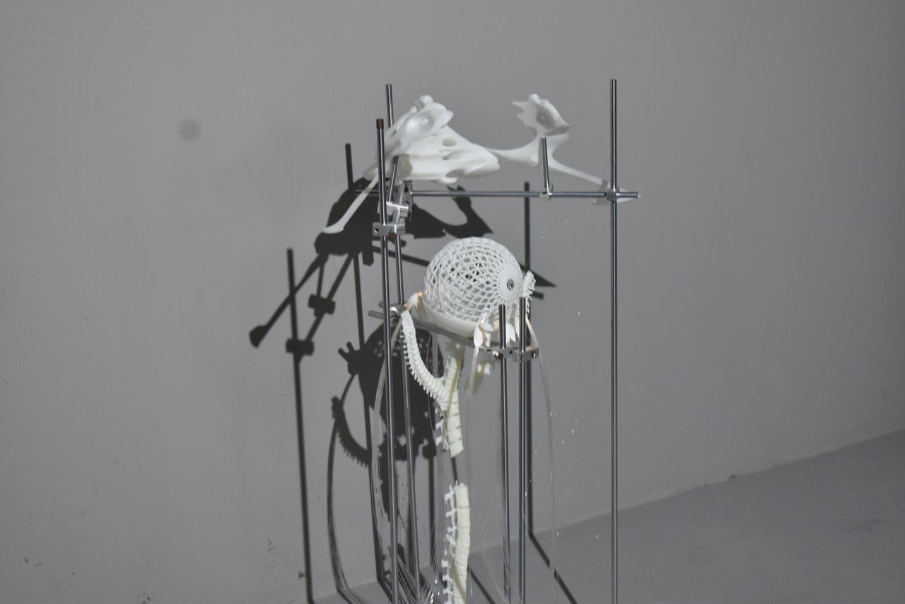 The installation casting sharp shadows on a pale wall.